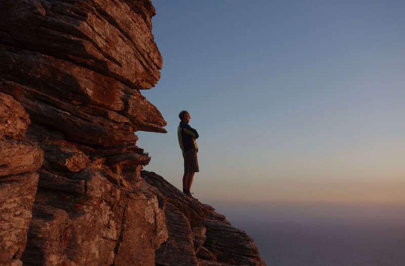 A person gazing far from a rocky landscape