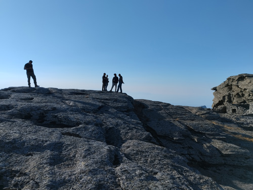 people silhouettes on a rocky terrain